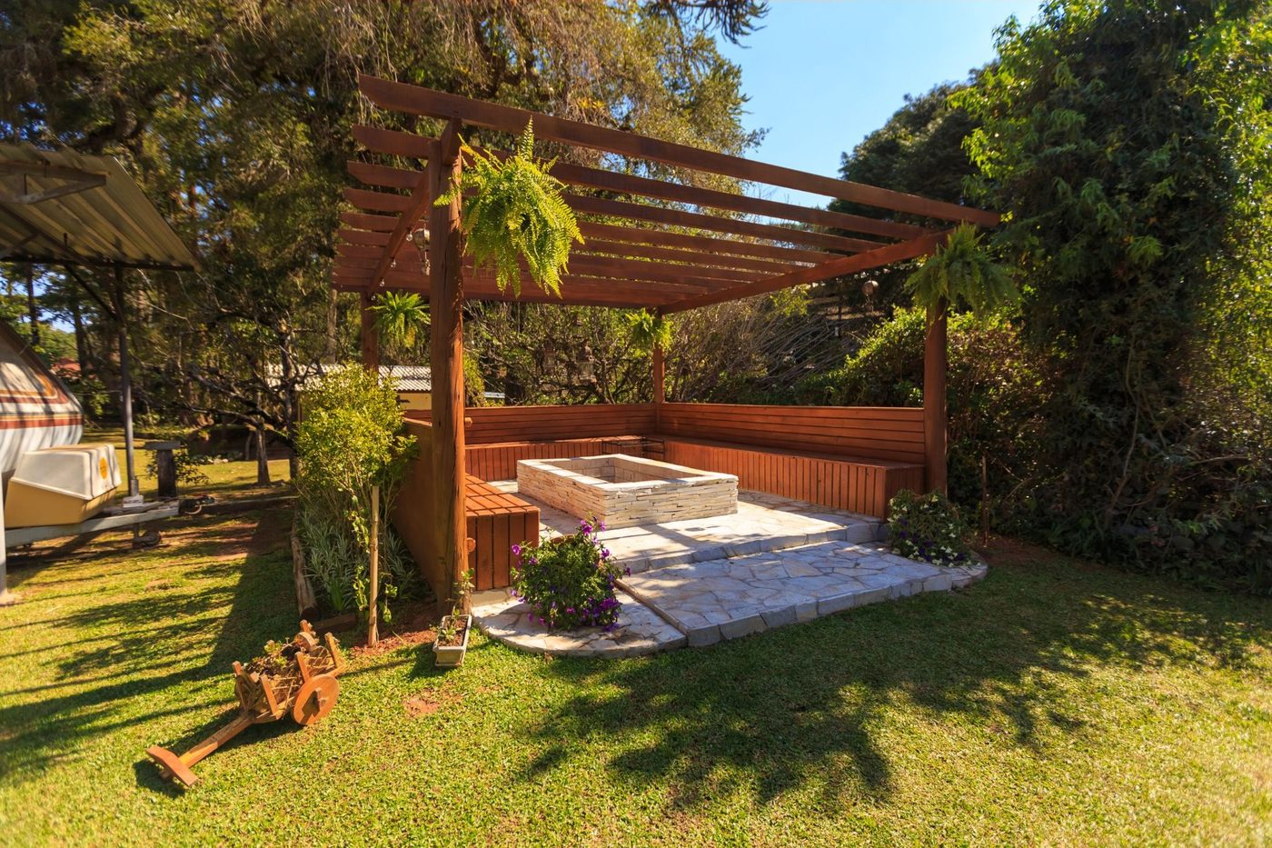 Reference image: a slatted timber pergola over a paved terrace and planted garden