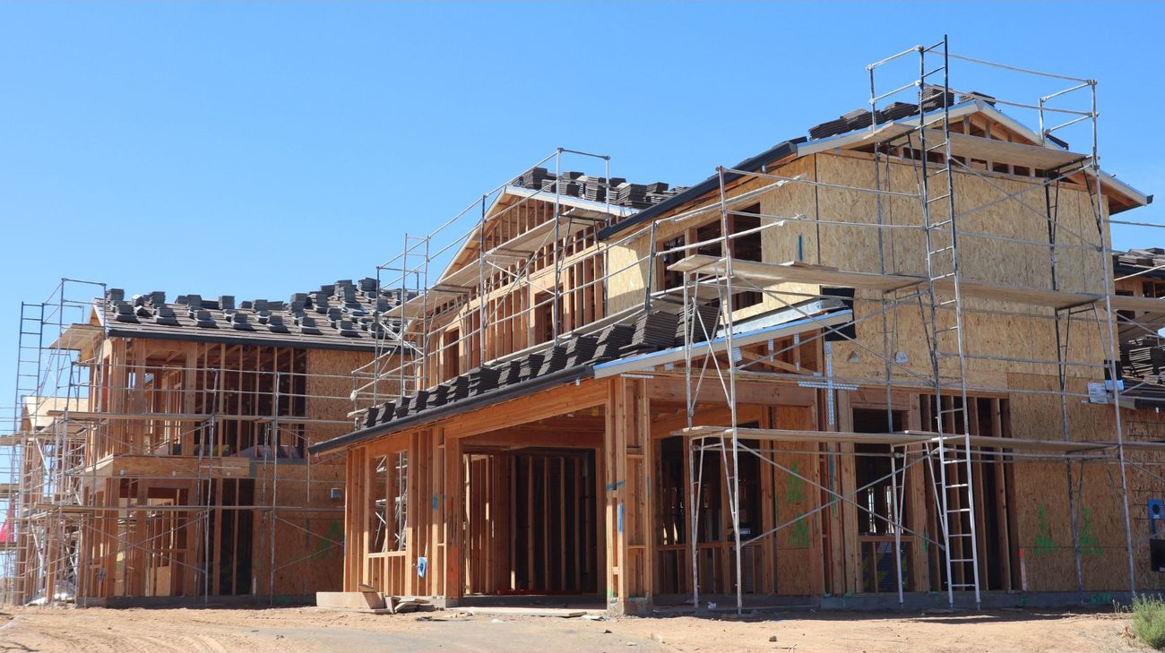 Reference image: timber framing and scaffolding on a house under construction