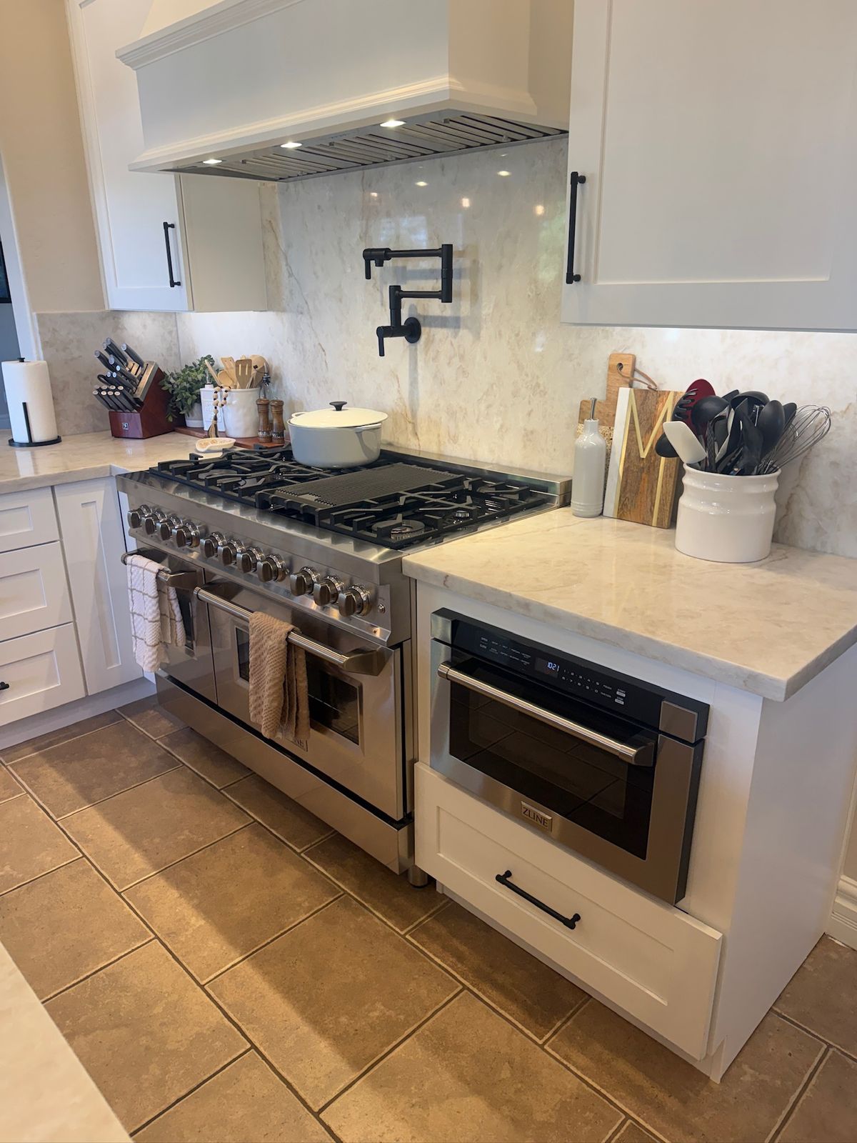 Stanley Brothers project: a professional range beside a microwave drawer under a painted hood